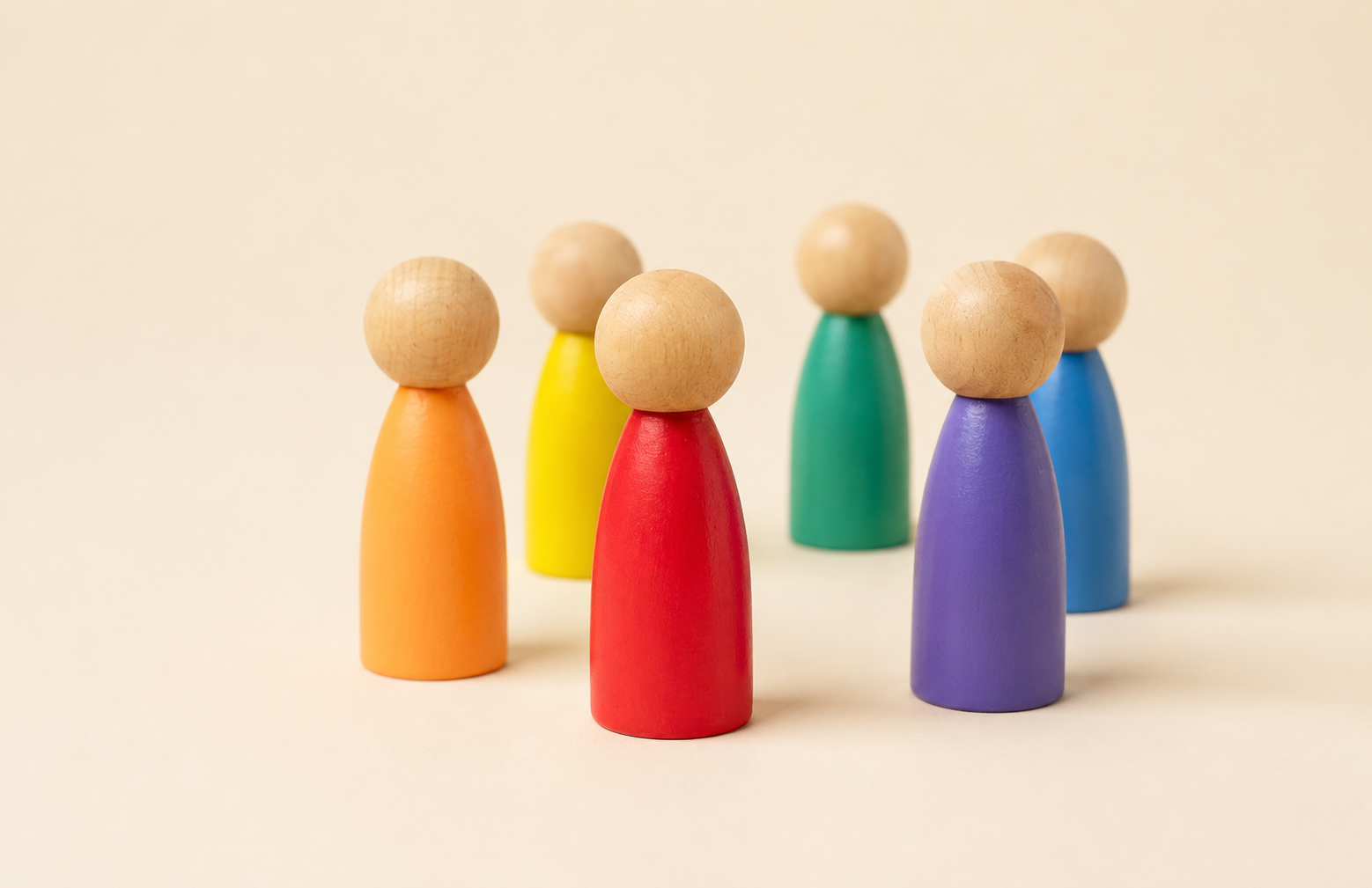 Colorful wooden figures representing a diverse multicultural workplace team